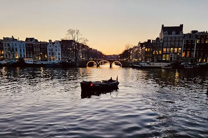 Evening canal cruise passing 17th-century canal houses in Amsterdam
